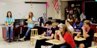 In a tropical island-themed classroom, seniors [from left] Hannah Patterson and Taylor Cox give helpful tips to freshmen on how to survive high school, and succeed.