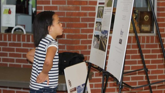Sophie Starnes, a fourth grader at O’Neal Elementary, views the architectural renderings of her future school building.