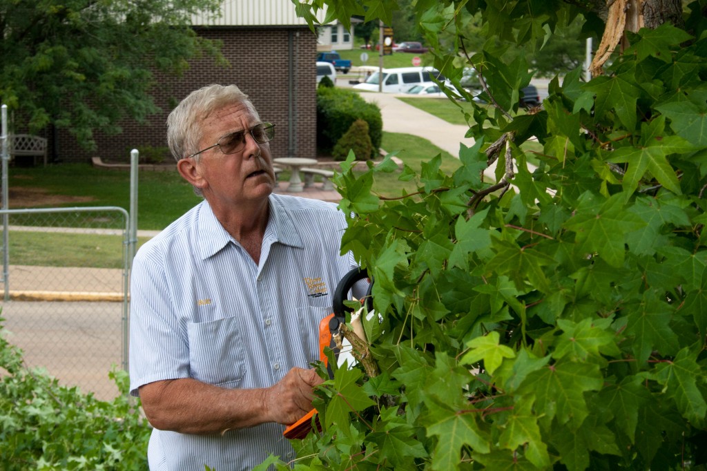 Bud Pinner, Groundskeeper at Three Rivers College and this year’s Missouri “Outstanding Older Worker of the Year” award winner for Region 7, trims back an overgrown tree on the college’s Poplar Bluff campus.