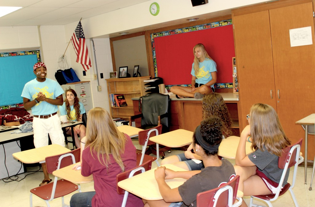 Accompanied by senior classmates [right to left] Dana Ziomek and Madison Bulger, Ridge Hester introduces himself to freshmen in a fact-sharing game his group of ambassadors invented.
