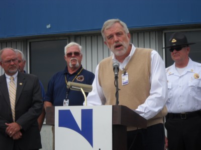 Noranda President and CEO Layle K. “Kip” Smith informs a crowd about layoffs at the plant Tuesday at New Madrid flanked by officials at a press conference Tuesday at the company’s smelter