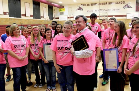 UCAN board president Dennis Hanes surprises Hope Conover by presenting her with a plaque on behalf of the organization for helping to make Pink-Out Day a success.