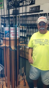 Standing next to his own “Lou Mansfield Signature Series” rods display rack.