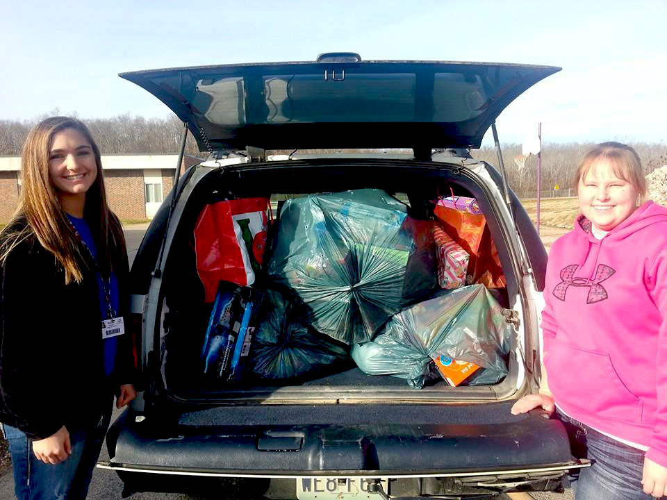 AmeriCorps tutors [left] Brooke Sheppard and Jessica Uhl of the 5th & 6th Grade Center fill a vehicle with donations to be delivered to the AmeriCorps office.