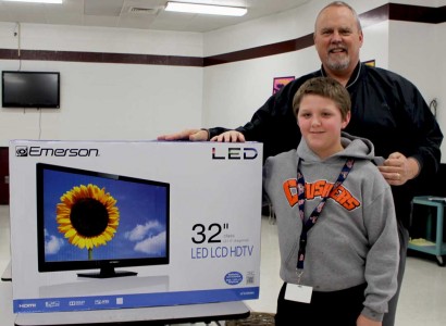 PBJHS Principal Bob Case presents student Dillon Rice with an LED television. 
