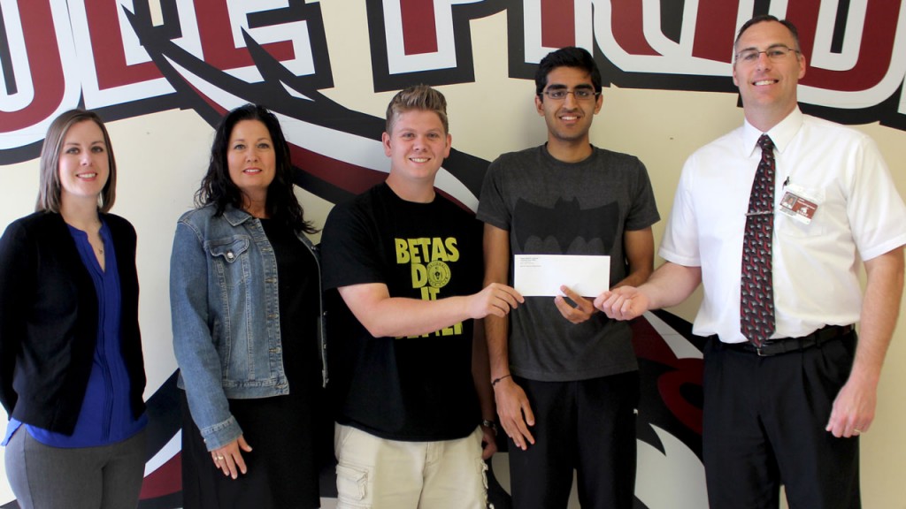 Cutline: Presenting Zain Siddiqui (second from right) with his scholarship on Wednesday, April 22, are (from left) Poplar Bluff Public School Foundation Vice-President Emily Hogg, Donna and Isaac Laseter, and PBHS Principal Mike Kiehne.