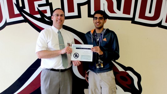 Zain Sidiqui is presented the certificate honoring her as a top academic student of 2015 on Wednesday, April 8, is PBHS Principal Mike Kiehne.