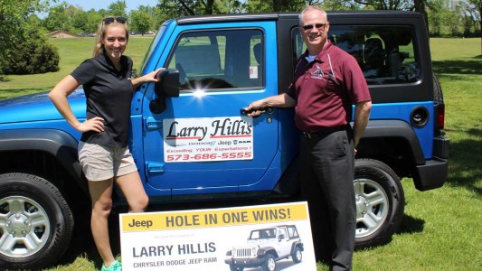 Julie Limpert of Larry Hillis Chrysler Dodge Jeep Ram presents the two-door 2015 Jeep Wrangler Sport, with R-I representative Rod Priest, assistant superintendent of business.