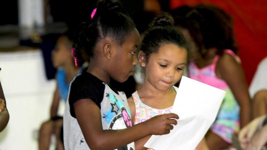 Second graders (from left) Jekaila Lathon of O’Neal and Sky Reed of Oak Grove perform a skit entitled “Fair.”