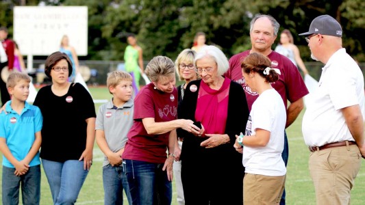 Four generations of the Giambelluca family accept a state championship ring from Beth Lewis-Muse and R-I Superintendent Chris Hon (right) in honor of Sam Giambelluca.