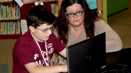 Jennifer Jackson gives her son Cooper a pep talk during a one-minute practice round prior to the Math Counts competition.